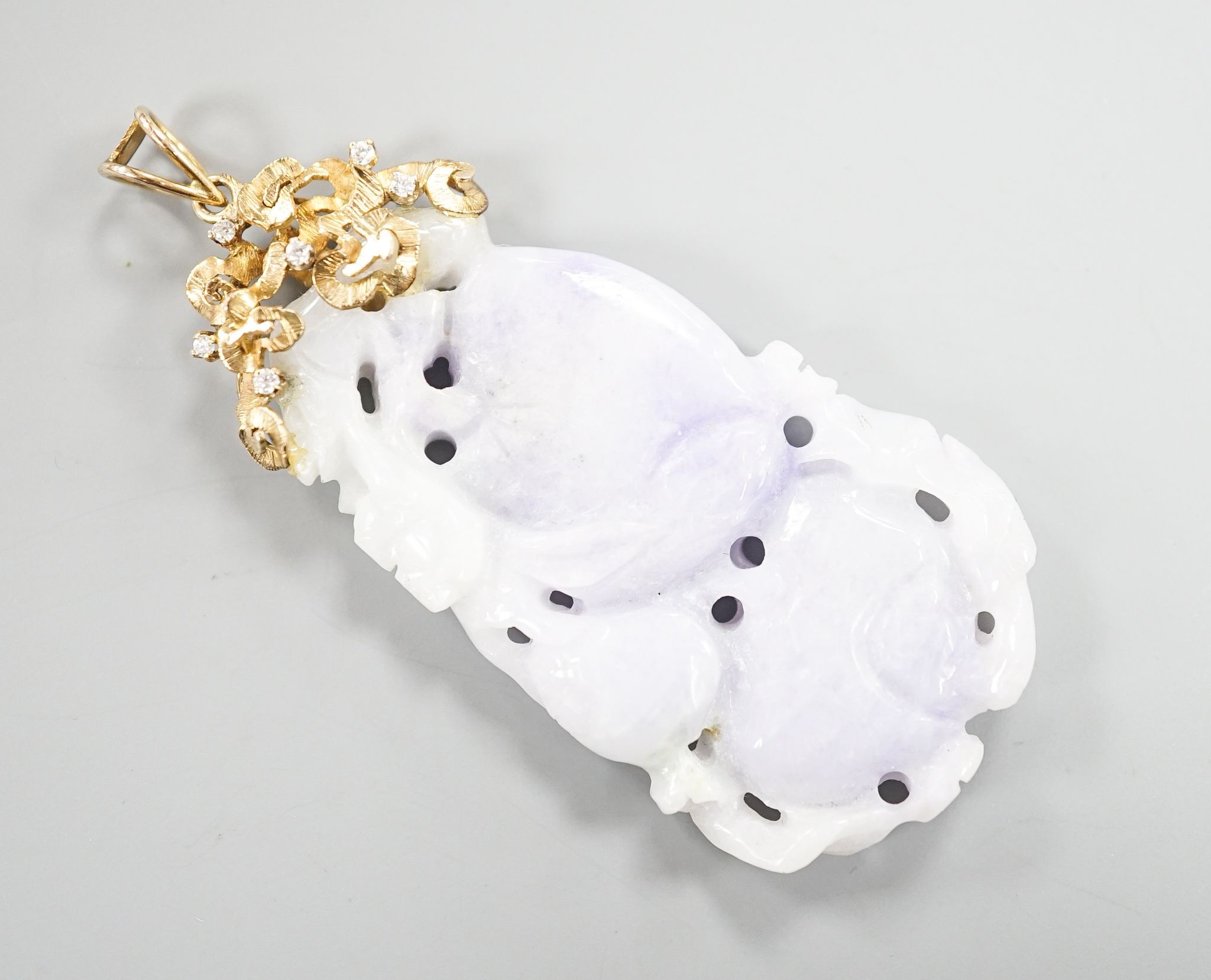 A 14k yellow metal mounted carved jade and diamond chip set pendant, overall 66mm, gross weight 19.4 grams.
